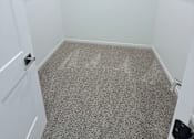Thumbnail 44 of 61 - A white closet with a carpeted floor and two shelves.
