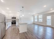 Thumbnail 50 of 61 - A spacious kitchen with white cabinets and a stainless steel refrigerator.