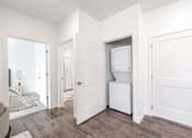 Thumbnail 30 of 34 - A white kitchen appliance is in a white cabinet in a white room.