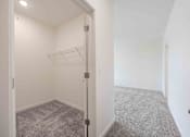 Thumbnail 45 of 61 - A white room with a grey carpet and a white door.