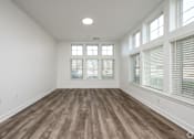 Thumbnail 12 of 48 - A room with wooden flooring and large windows.