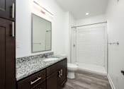 Thumbnail 10 of 48 - A bathroom with a white sink and a white toilet.