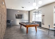 Thumbnail 19 of 34 - A room with a pool table and a television.