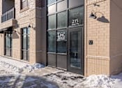 Thumbnail 14 of 34 - The building has a glass door with a sign that says LNC.