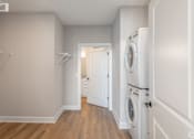 Thumbnail 12 of 34 - A laundry room with a washer and dryer in it.