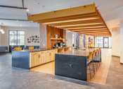 Thumbnail 30 of 34 - A modern kitchen with wooden beams and a black counter.