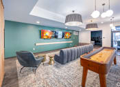 Thumbnail 28 of 34 - A room with a pool table and a row of chairs.