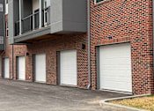 Thumbnail 38 of 61 - A row of garage doors on a brick building.