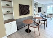 Thumbnail 8 of 61 - A modern dining area with a wooden table and chairs.