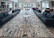 Thumbnail 3 of 61 - A large open space with a long marble table and couches.