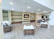 Thumbnail 9 of 61 - A living room with a grey couch, a white chair and a coffee table.