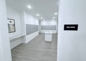 Thumbnail 31 of 61 - A white room with a sign that says "Mail Room".