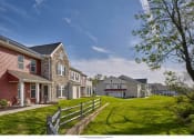 Thumbnail 6 of 6 - a row of houses on a hill with a green lawn and a fence
