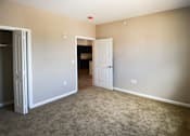 Thumbnail 17 of 18 - A room with a white door and a carpeted floor.at Union at 16th, Indianapolis Indiana
