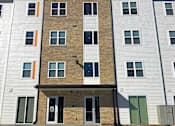 Thumbnail 4 of 13 - A building with a brown brick facade and white siding.at Union at Crescent, Bloomington, IN 47404  