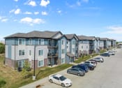 Thumbnail 2 of 26 - a row of townhomes with cars parked in front of them  at Union at Wiley, Iowa, 52404