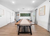 Thumbnail 11 of 26 - a long wooden table with black chairs in a room with white walls  at Union at Wiley, Iowa, 52404