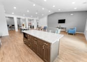 Thumbnail 13 of 22 - A modern kitchen with a large island and wooden floors.at Union at North Crossing, Iowa, 50703