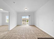 Thumbnail 11 of 21 - Carpeted Living Area at Union at the Loop, Lawrence