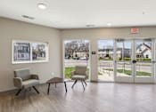 Thumbnail 5 of 27 - A waiting room with two chairs and a table at Union at 16th, Indianapolis, IN