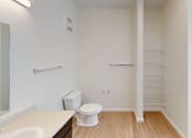 Thumbnail 12 of 18 - A white toilet sits in a small bathroom with a sink and a mirror.at Union at 16th, Indiana