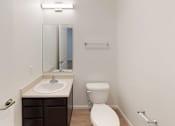 Thumbnail 14 of 18 - A white toilet sits next to a sink in a small bathroom.at Union at 16th, Indianapolis, IN