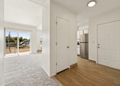 Thumbnail 34 of 74 - A white interior with a kitchen in the background.