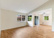 Thumbnail 35 of 66 - Cascade Woods living area with sliding glass door and natural light