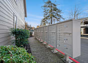 Thumbnail 33 of 37 - A long row of electrical boxes are lined up on the sidewalk.