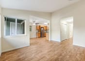 Thumbnail 36 of 66 - A room with wooden floors and white walls.