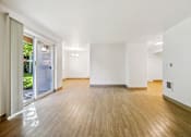 Thumbnail 4 of 37 - A room with wooden floors and white walls.