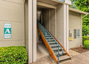 Thumbnail 3 of 36 - A staircase with a blue railing leads to a doorway with a sign that reads 212 A 112.
