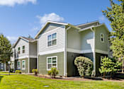 Thumbnail 68 of 74 - A two-story house with a grey and white exterior.