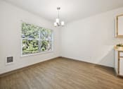 Thumbnail 6 of 74 - A room with a window and a wooden floor.