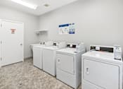 Thumbnail 69 of 74 - A laundry room with washers and dryers.