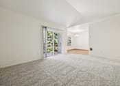 Thumbnail 8 of 74 - A spacious room with a grey carpet and white walls.