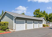 Thumbnail 71 of 74 - A two-car garage with a grey roof and white doors.