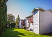 Thumbnail 31 of 34 - A house with a red awning and a white garage door.