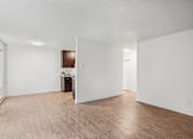 Thumbnail 17 of 44 - A room with wooden flooring and white walls.