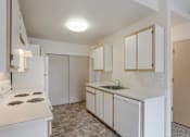 Thumbnail 10 of 36 - A kitchen with white appliances and cabinets.