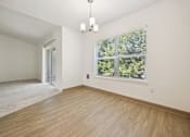 Thumbnail 10 of 74 - A room with a window and a carpet on the floor.