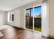 Thumbnail 14 of 31 - A room with a sliding glass door leading to a backyard.