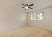 Thumbnail 15 of 66 - Empty room with a ceiling fan and a window.