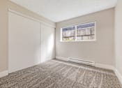 Thumbnail 18 of 31 - A room with a carpeted floor and a window.