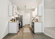 Thumbnail 12 of 74 - A modern kitchen with white cabinets and stainless steel appliances.