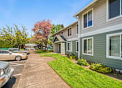 Thumbnail 13 of 35 - A row of houses with a green lawn in front.