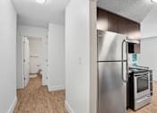 Thumbnail 20 of 44 - A kitchen with a stainless steel refrigerator and oven.