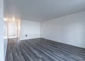Thumbnail 27 of 34 - A room with a wooden floor and white walls.