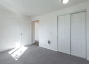 Thumbnail 33 of 34 - A room with white walls and a grey carpet.