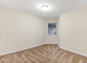 Thumbnail 47 of 66 - A room with a carpeted floor and a window.